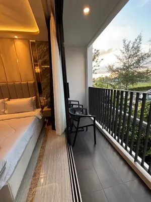 a bedroom with a balcony with a bed and a window at Bellevue Lagoon Boutique - Bang Tao, Phuket Laguna in Laguna Phuket