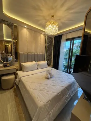 a bedroom with a white cat sitting on a bed at Bellevue Lagoon Boutique - Bang Tao, Phuket Laguna in Laguna Phuket