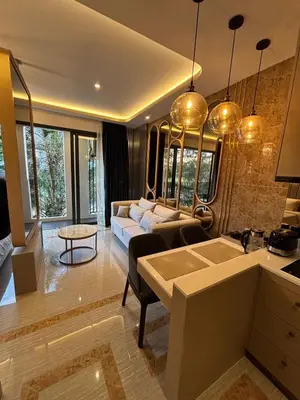 a living room with a couch and a table at Bellevue Lagoon Boutique - Bang Tao, Phuket Laguna in Laguna Phuket