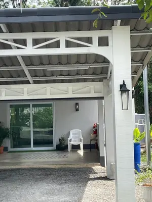a white pergola with a white bench on a patio at Butterfly Home Phuket