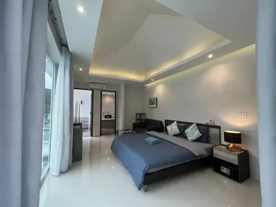 a bedroom with a bed and a living room at 3bedrooms pool Villa Kamala in Kamala Beach