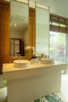 a bathroom with two sinks and a large mirror at Beautiful Pool Villa in Pavilion and Tropical Oasis in Ban Pak Lak