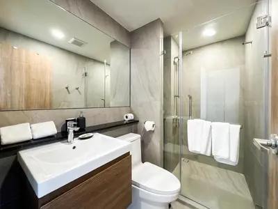 a bathroom with a sink and a toilet and a shower at Comfortable 2Bdr Bangtao Space Condo in Ban Thalat Choeng Thale
