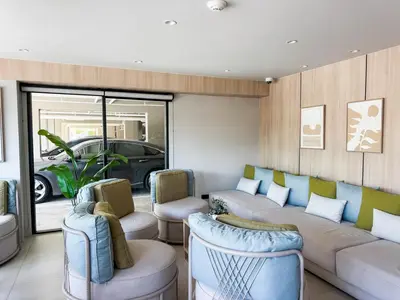 a living room with a couch and chairs and a car at Comfortable 2Bdr Bangtao Space Condo in Ban Thalat Choeng Thale