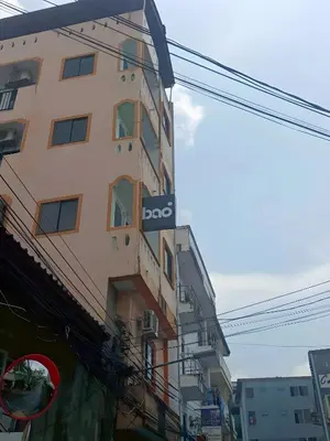 a tall building with a sign on the side of it at BAO Phuket Patong- ไสน้ำเย็น ซอย 1 in Patong Beach