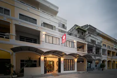 a white building with a sign in front of it at Chinoir Boutique Phuket Town in Phuket