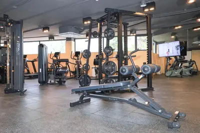 a gym with a bunch of exercise equipment in it at The Sunshine Beach studio with a great view in Layan Beach