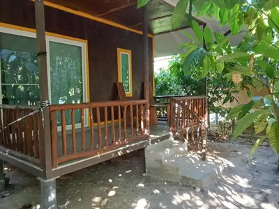 a porch of a house with a tree at Kohyaonoi Lastfisherman in Ko Yao Noi