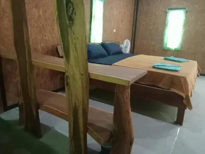 a room with a bunk bed and a table in a room at Kohyaonoi Lastfisherman in Ko Yao Noi