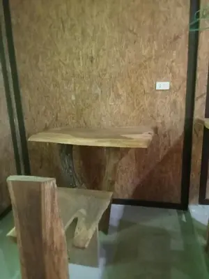 a wooden table sitting inside of a room at Kohyaonoi Lastfisherman in Ko Yao Noi