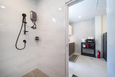 a bathroom with a shower with a camera on the wall at New Modern Escape Patong Poolvilla 2 mins to beach in Patong Beach