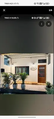 a house with potted plants in front of it at BaanNiraบ้านนิรา in Ban Sam Kong