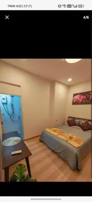 a room with a bed and a table in it at BaanNiraบ้านนิรา in Ban Sam Kong