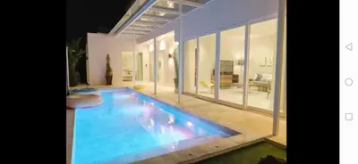 a swimming pool in the middle of a house at Pool Villa in Phuket 3rooms for family in Kamala Beach