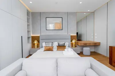 a bedroom with a large white bed and a couch at V293 Be the First! Brand New Elite Pool Villa in Ban Thalat Choeng Thale