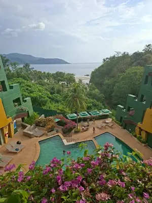 a view of a resort with a swimming pool and the ocean at The Aspasia Kata Beach in Kata Beach