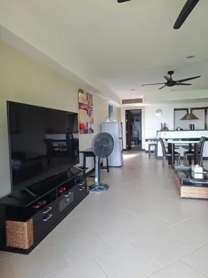 a living room with a large flat screen tv at The Aspasia Kata Beach in Kata Beach