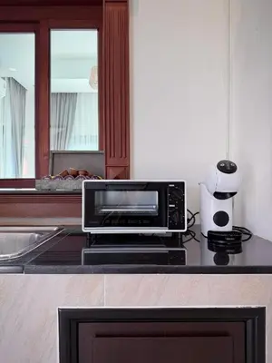 a microwave oven sitting on a counter in a kitchen at ozone pool villa phuket in Ban Pa Khlok