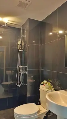a bathroom with a shower and a toilet and a sink at Hillside - Seashore Naiyang Beach in Phuket