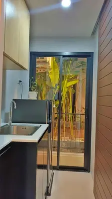 a kitchen with a sink and a window with plants at Hillside - Seashore Naiyang Beach in Phuket