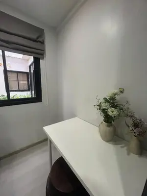a white room with a table and a window at Hillside - Seashore Naiyang Beach in Phuket