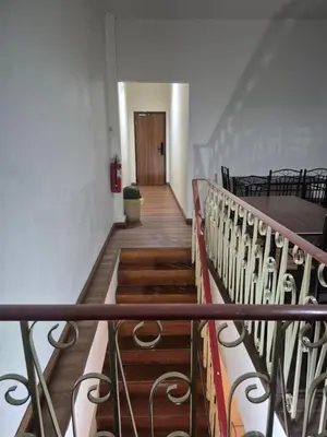 a stairway in a building with a stair case at HOM's HOSTEL in Phuket Town