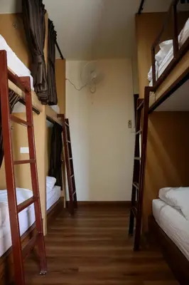 a room with four bunk beds in a hostel at HOM's HOSTEL in Phuket Town