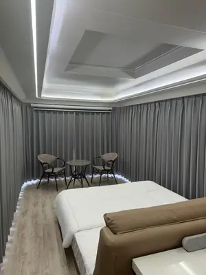 a bedroom with a bed and a table and chairs at Luxury Capsule Haus Phuket in Panwa Beach