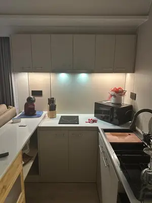 a kitchen with white cabinets and a stove at Luxury Capsule Haus Phuket in Panwa Beach