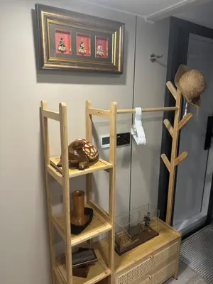 a shelf in a room with a picture on the wall at Luxury Capsule Haus Phuket in Panwa Beach