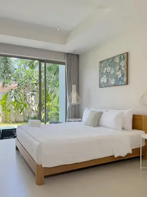 a bedroom with a large bed and a large window at Trichada Tropical Private Tropical 3BR Pool Villa in Laguna Phuket