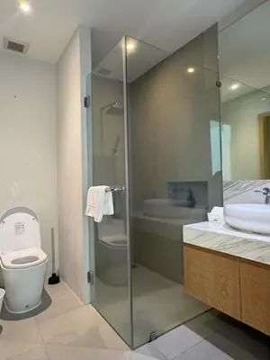 a bathroom with a shower and a toilet and a sink at Trichada Tropical Private Tropical 3BR Pool Villa in Laguna Phuket