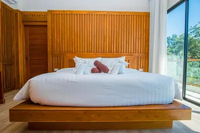 a bed with two teddy bears sitting on top of it at White Villa Phuket in Ban Saiyuan (1)
