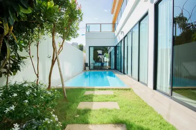 an external view of a house with a swimming pool at White Villa Phuket in Ban Saiyuan (1)