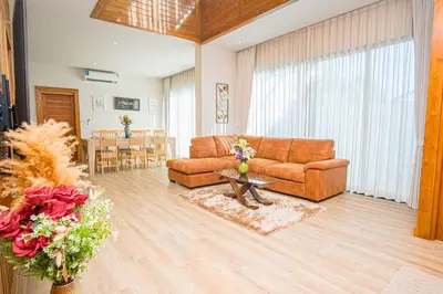 a living room with a couch and a table at White Villa Phuket in Ban Saiyuan (1)