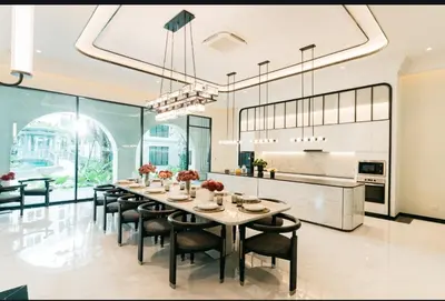 a dining room with a table and chairs and a kitchen at The Title Legendary swimming pool in Phuket
