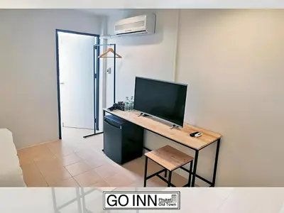 a room with a desk with a computer on it at GO INN Phuket old Town in Ban Lo Long