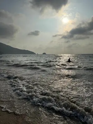 a person is in the water at the beach at VIP Great Hill Airport in Phuket
