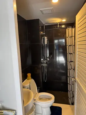 a bathroom with a shower and a toilet and a sink at VIP Great Hill Airport in Phuket