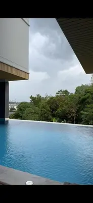 a view of a swimming pool with trees in the background at VIP Great Hill Airport in Phuket