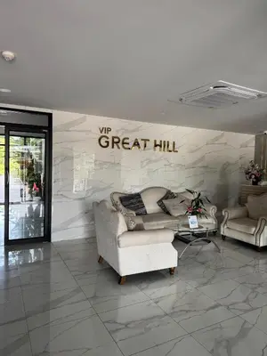 a living room with two couches and a sign that reads great hill at VIP Great Hill Airport in Phuket