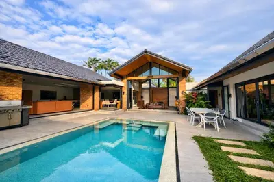 a swimming pool in the backyard of a house at Golf Paradise 4 BR Smart Home Pool Villa at Loch Palm Golf Course Kathu in Ban Kathu