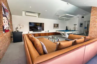 a living room with a couch and a pool table at Golf Paradise 4 BR Smart Home Pool Villa at Loch Palm Golf Course Kathu in Ban Kathu