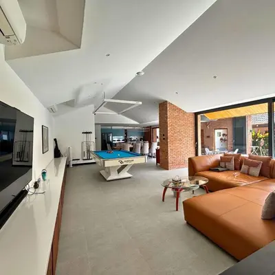 a living room with a couch and a pool table at Golf Paradise 4 BR Smart Home Pool Villa at Loch Palm Golf Course Kathu in Ban Kathu