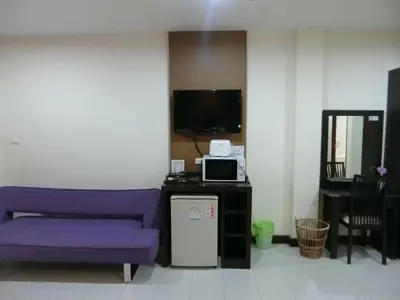 a living room with a purple couch and a tv at Bed & Bath in Kata Beach