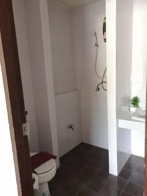 a bathroom with a toilet and a sink at Bed & Bath in Kata Beach