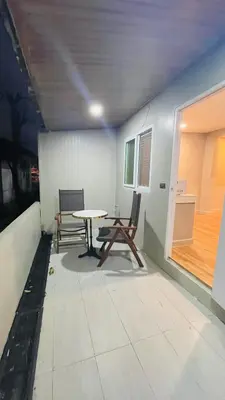 a room with a table and chairs and a window at House of Lee-Party room in Ban Huai Sai