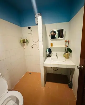 a bathroom with a toilet and a sink and a shower at MILD ISLAND STAY ROOm in Phi Phi Don
