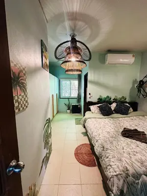 a bedroom with two beds and a chandelier at MILD ISLAND STAY ROOm in Phi Phi Don