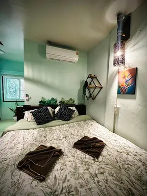 a bedroom with a bed with two robes on it at MILD ISLAND STAY ROOm in Phi Phi Don